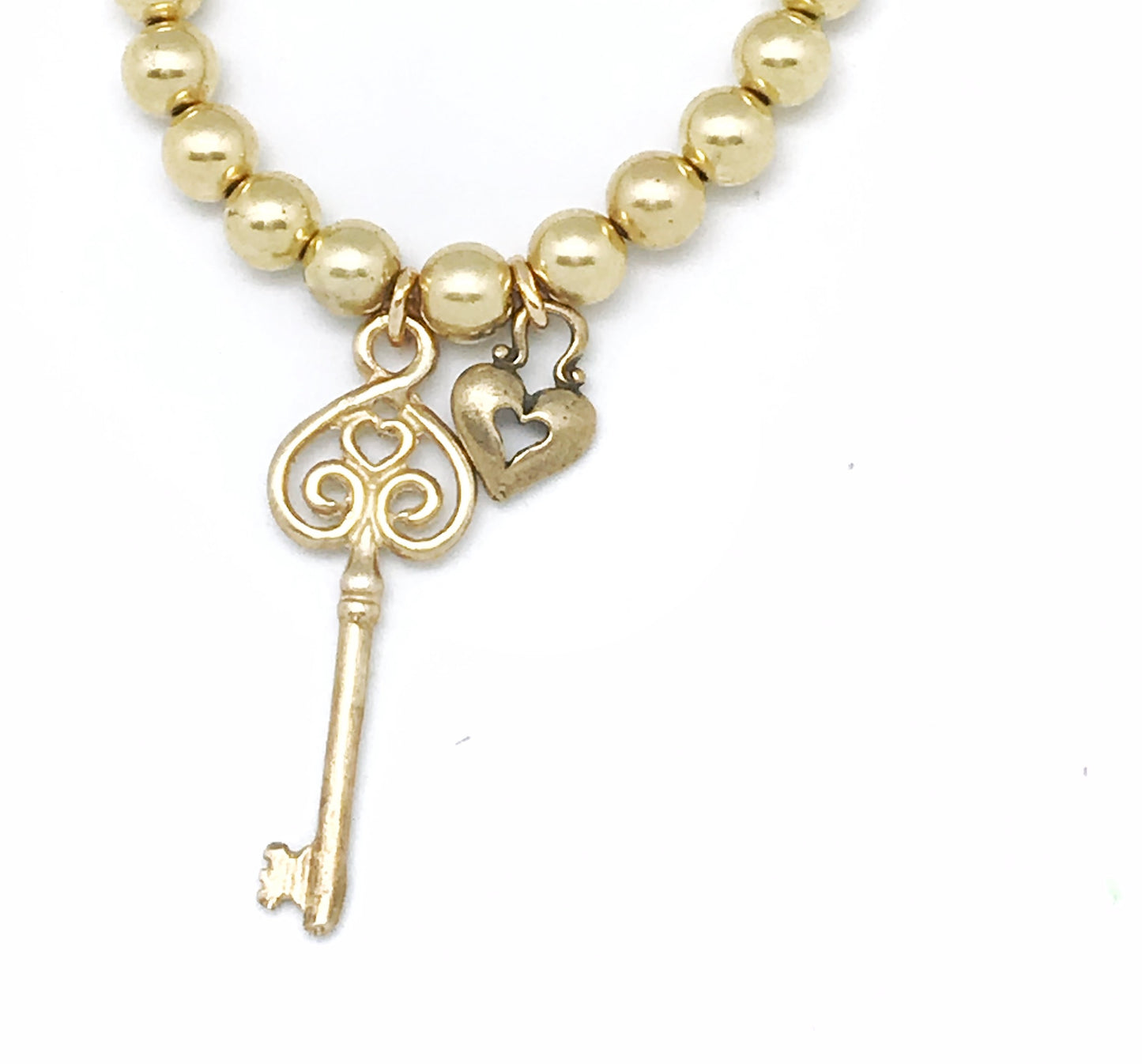 Pulsera candado y llave Love . Dorado elástica.