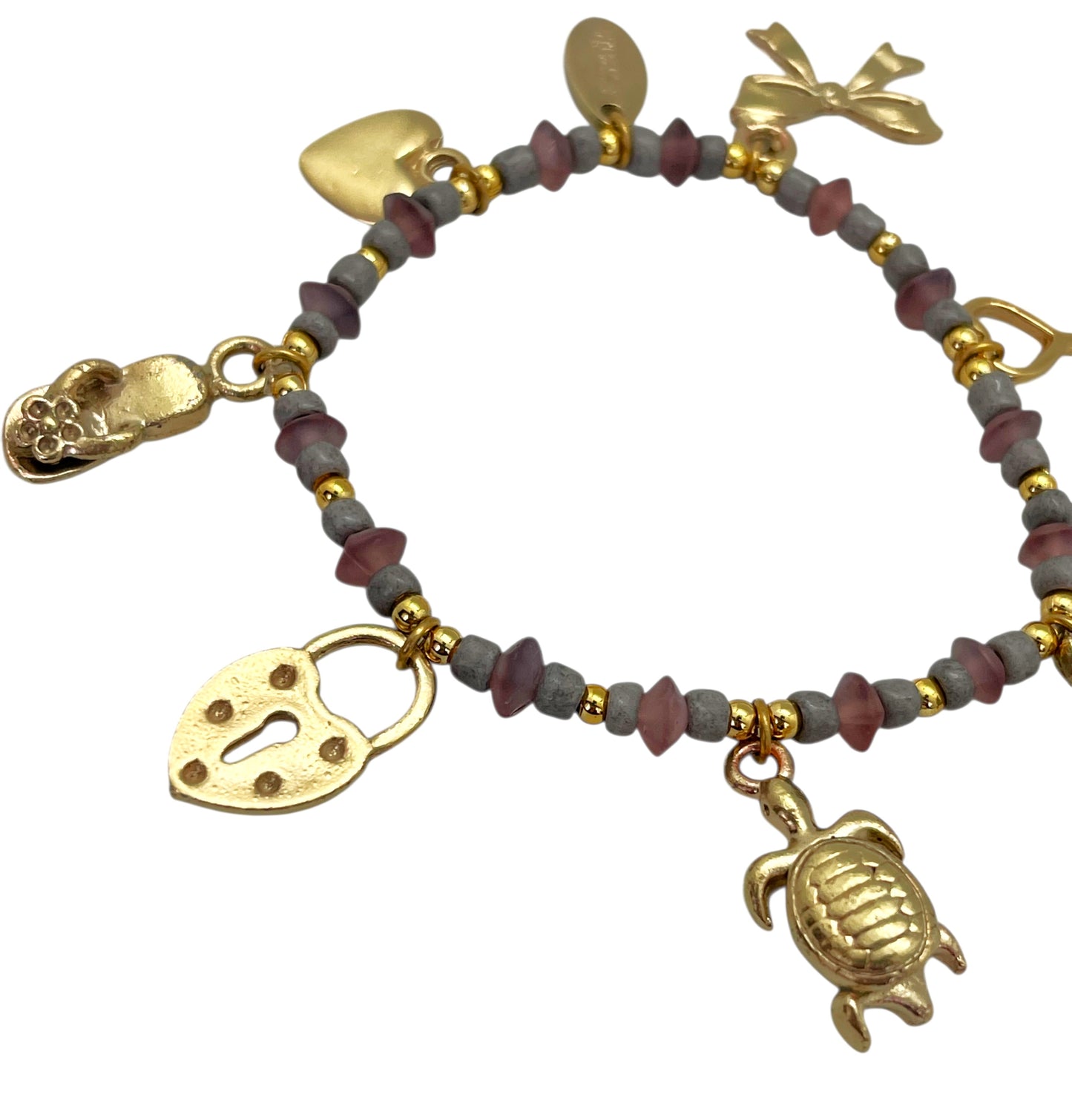 Pulsera elástica charms dorado con resinas colores tono rosa