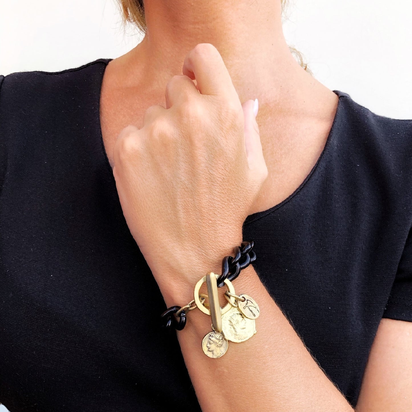 Pulseira de corrente preta com fecho central e pingentes