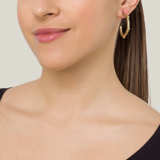 Golden hoop earring with tassels