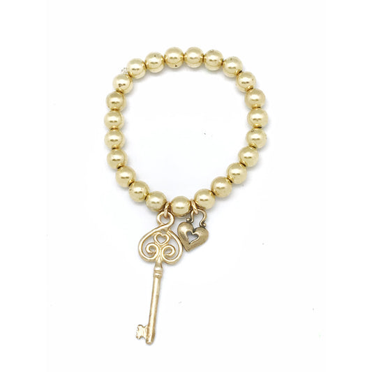Love lock and key bracelet. Elastic golden.